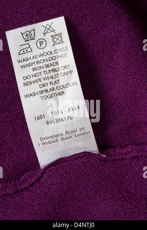 label with washing instructions in jumper - care washing symbols and instructions Stock Photo