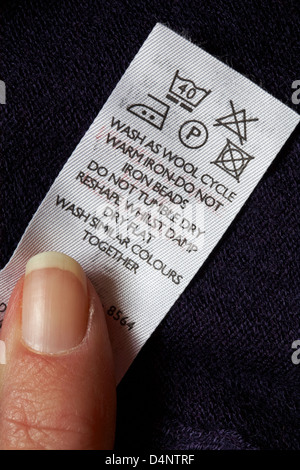 label with washing instructions in jumper - care washing symbols and ...