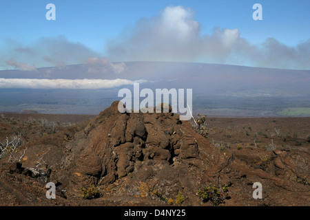 Mauna Loa volcano with Rainbow over old lava flow Kilauea Volcanoes National Park Hawaii the big island Stock Photo