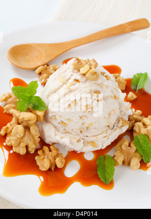 Scoop of walnut ice cream with caramel sauce Stock Photo