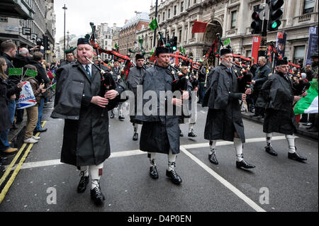 Essex Caledonian Pipe Band march on the St Patrick's Day Parade on 17/03/2013 at Westminster, London. The parade set off from Piccadilly by Green Park at 12 noon and traveled to Whitehall.  A main attraction was The Puca, a giant inflatable dragon designed by leading artist Keith Payne. Picture by Julie Edwards Stock Photo