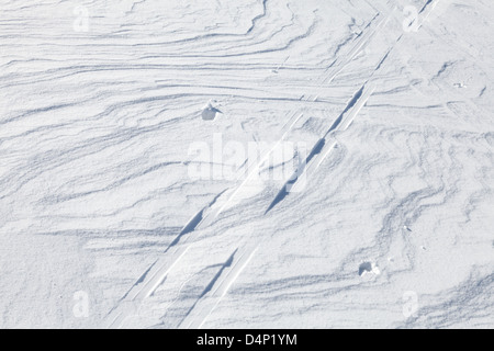 Snow and Ski track above shining snowdrift with nice curved shadows Stock Photo