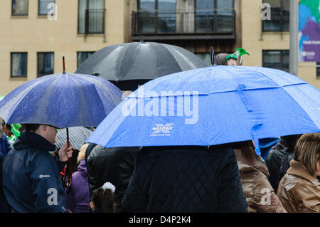 People sheltering under umbrellas in heavy rain Stock Photo