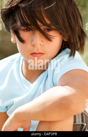 Close-up of a young boy staring off in the distance Stock Photo