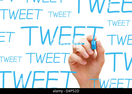 Hand writing Tweet with blue marker on transparent wipe board. Stock Photo