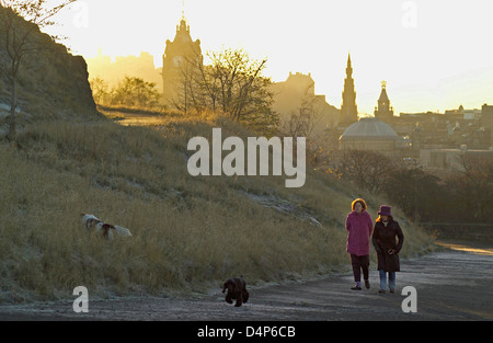 two women dog walkers on calton hill at sunrise on frosty day Stock Photo