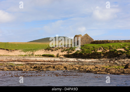 Offshore view of broch and stone building on Isle of Noss National Nature Reserve, Shetland Islands, Scotland, UK, Britain Stock Photo