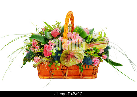 Flower bouquet arrangement centerpiece in a wicker gift basket isolated on white background. Stock Photo