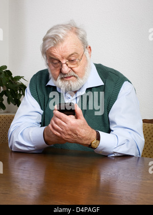 Senior man using his new smart phone Stock Photo