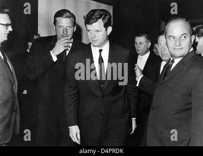 (dpa file) A file picture dated 09 May 1966 captures U.S. Senator Ted Kennedy (C) with Rainer Barzel (R) and Walter Leisler Kiep (L), who accompany him to the Hotel Intercontinental where Kennedy held a speech, on the day of his arrival in Frankfurt Main, Germany. Stock Photo