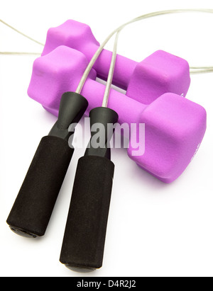 Pink dumbbells in a neoprene cover and Skipping rope, measuring tape Stock Photo
