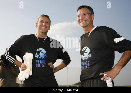Adidas CEO, Herbert Hainer (R), and Puma CEO, Jochen Zeitz, on the pitch ahead of a soccer friendly between two company sides in Herzogenaurach, Germany, 21 September 2009. The friendly took place within the scope of the ?Peace One Day? initiative. It was the first joint event by the two companies since the 1940s, when the Dassler brothers split their company into rivals adidas and Stock Photo