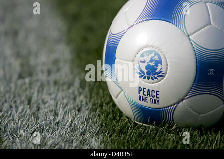 One soccer ball lies on the grass, black and white ball Stock