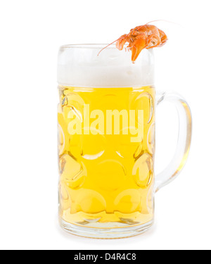 Frothy glass of light golden beer with a single cooked pink prawn balanced carefully on the rim isolated on white Stock Photo