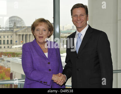 Angela Merkel, German Chancellor and leader of the conservative Christian Democratic Union party (CDU) and Guido Westerwelle, leader of the pro-business Free Democrats (FDP) meet at the Chancellery in Berlin, Germany, 28 September 2009. Merkel's conservatives vowed on Monday to seal a coalition deal, including tax cuts, with the pro-business Free Democrats (FDP) within a month afte