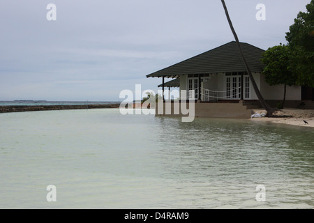 Meedhupparu Island in the Maldives showing flooding over the concrete defense wall possibly due to global warming Stock Photo