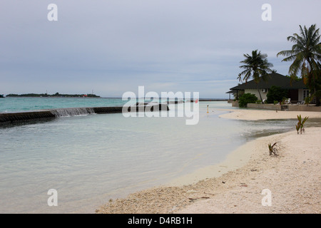 Meedhupparu Island in the Maldives showing flooding over the concrete defense wall possibly due to global warming Stock Photo