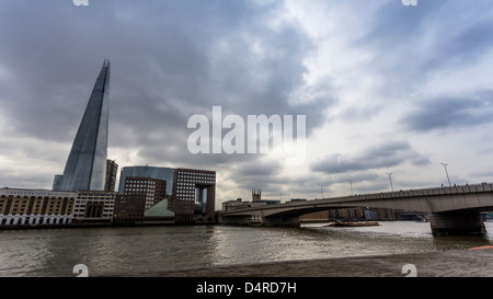 The Shard and London Bridge from the river side in a cloudy morning Stock Photo