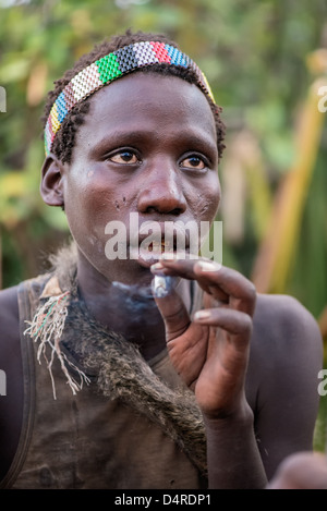 Hadza hunter smoking marijuana Stock Photo
