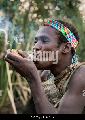 Hadza hunter smoking Stock Photo