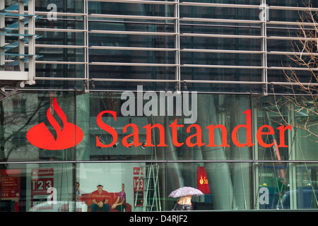 A woman walks in front of the Santander UK Head Office at Regent's Place, London. Stock Photo