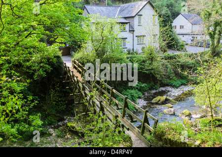 Footbridge over the East Lyn River at Rockford in Exmoor during spring near Lynmouth, Devon, England. Stock Photo