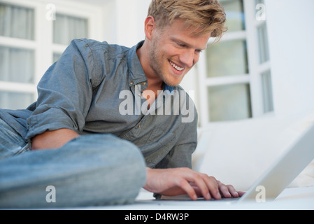 Young man using laptop computer outdoors Stock Photo