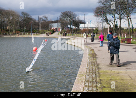 Enthusiasts sailing radio controlled model yachts in South Marine Park South Shields north east England UK Stock Photo