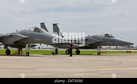 Two F-15's from the 18th Wing at Kadena Air Base, Okinawa sit at the end of runway to complete thier pre-flight checks. Stock Photo