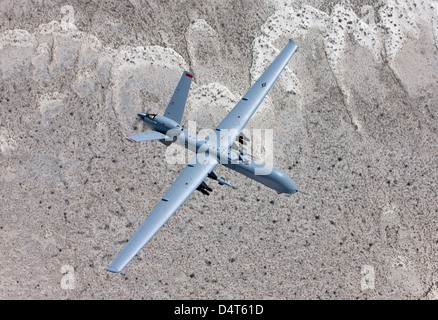 An MQ-9 Reaper flies a training mission over the White Sands National Monument in Southern New Mexico. Stock Photo