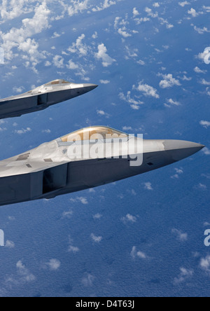 Two planes flying with a F-22 Raptor Stock Photo - Alamy