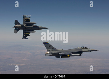 A pair of F-16's fly in formation over Arizona. Stock Photo