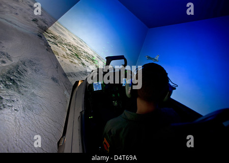 A pilot from the 56th Fighter Wing in Luke Air Force Base, Arizona, flies the F-16 simulator. Stock Photo