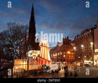 princes street and scott monument at night during hogmanay with helter skelter Stock Photo