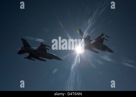 A pair of F-16's from the 162nd Fighter Wing fly in formation during a training mission out of Tucson, Arizona. Stock Photo