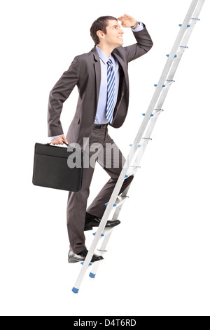 Full length portrait of a businessman with briefcase climbing a ladder isolated on white background Stock Photo