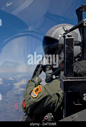 A F-15 pilot from the 173rd Fighter Wing looks over at his wingman during a training mission over Central Oregon. Stock Photo