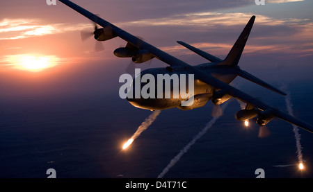 A C-130 Hercules from the Missouri Air National Guard releases flares during a training mission over Kansas. Stock Photo