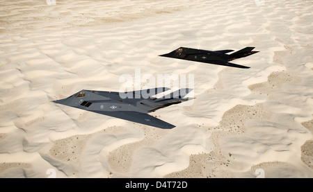 Two F-117 Nighthawk stealth fighters fly over White Sands National Monument. Stock Photo