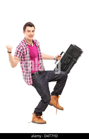Full length portrait of a young man holding a radio and gesturing happiness isolated on white background Stock Photo