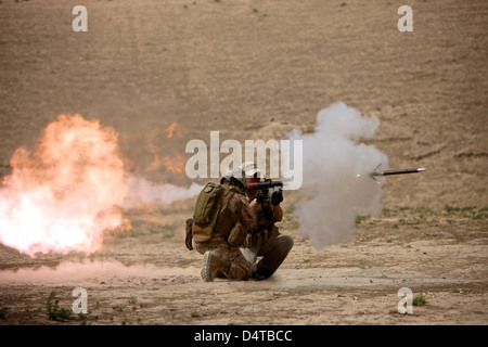 A U.S. Contractor fires a rocket-propelled grenade launcher. Stock Photo