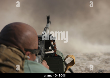 U.S. Contractor firing the automatic PKM 7.62 machine gun on the firing range in Kunduz, Afghanistan. Stock Photo