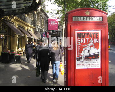 A red telephone booth at a well attended business road in London, United Kingdom, 26 October 2009. Photo: Johannes Reichert Stock Photo