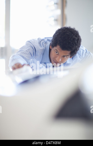 Salesman shining up new car Stock Photo