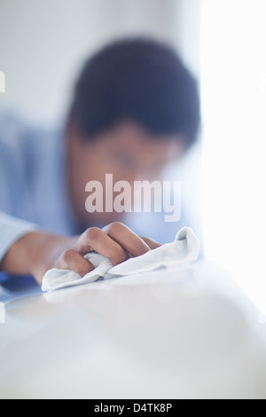 Salesman shining up new car Stock Photo