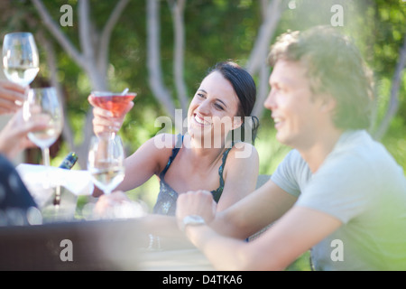 Friends toasting each other outdoors Stock Photo