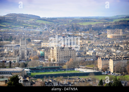 View across the rooftops of Bath to the Abbey (left) and Recreation Ground rugby stadium Somerset UK Stock Photo
