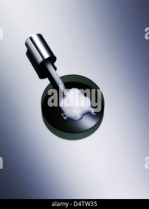 Dropper with lotion in petri dish Stock Photo