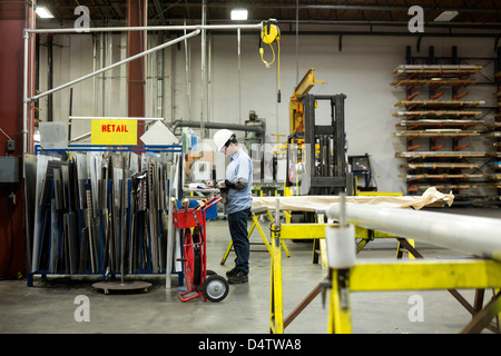 Worker standing in metal plant Stock Photo