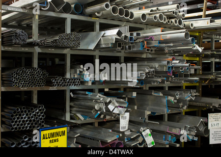 Shelves of aluminum pipes in plant Stock Photo